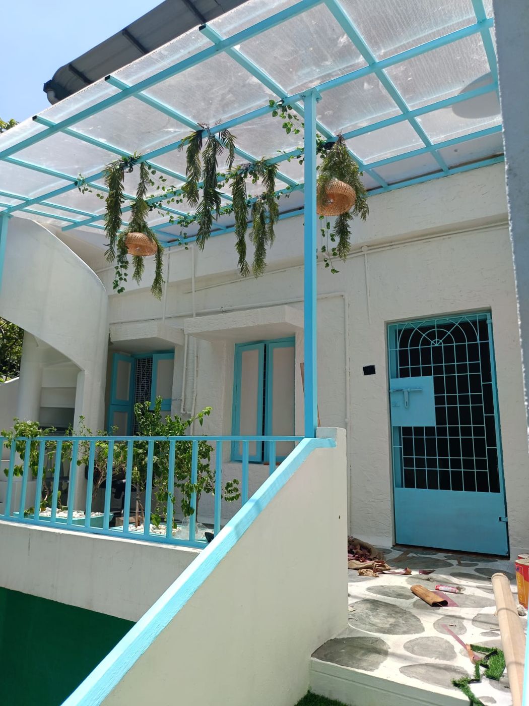 Light-blue pergola over the entrance court